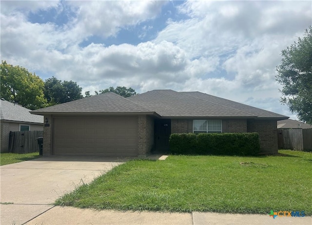 3502 Levy Ln, Killeen, TX 76542 - ranch-style home with brick siding, an attached garage, concrete driveway, and roof with shingles