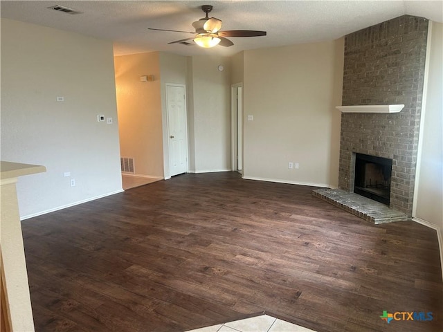 3502 Levy Ln, Killeen, TX 76542 - unfurnished living room with dark wood-style flooring, a ceiling fan, and a fireplace