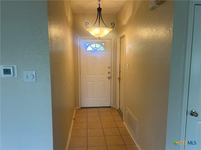 3502 Levy Ln, Killeen, TX 76542 - doorway featuring light tile patterned floors and a textured wall