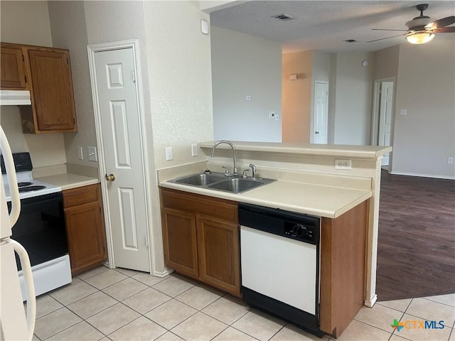 3502 Levy Ln, Killeen, TX 76542 - kitchen with white appliances, under cabinet range hood, a peninsula, brown cabinets, and a ceiling fan