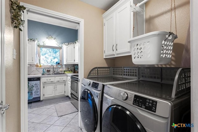 713 End O Trl, Harker Heights, TX 76548 - laundry room with washing machine and dryer, cabinet space, and light tile patterned floors