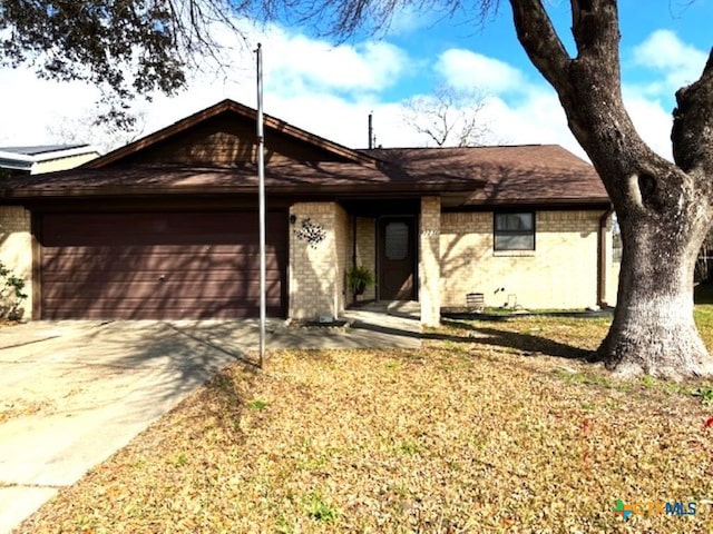 ranch-style house with a garage and a front lawn