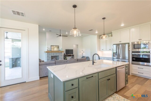 4324 Cedar Creek Rd, Temple, TX 76504 - kitchen with stainless steel appliances, a sink, light wood-type flooring, white cabinetry, and recessed lighting