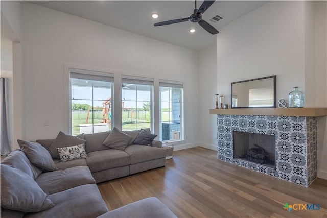 4324 Cedar Creek Rd, Temple, TX 76504 - living room featuring wood finished floors, a fireplace, a ceiling fan, baseboards, and recessed lighting