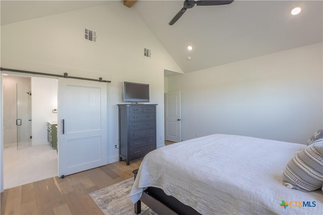 4324 Cedar Creek Rd, Temple, TX 76504 - bedroom featuring high vaulted ceiling, light wood finished floors, beam ceiling, a barn door, and recessed lighting