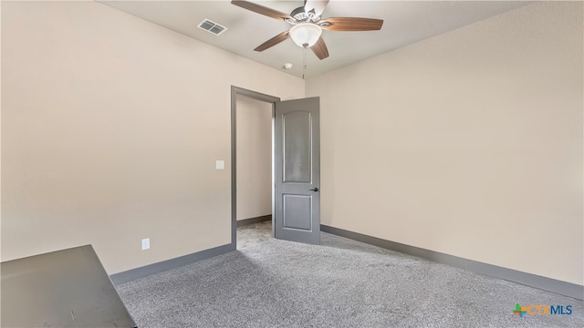 carpeted spare room with ceiling fan