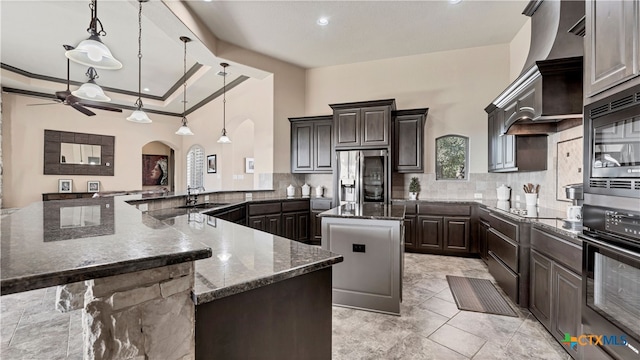 kitchen with black appliances, tasteful backsplash, pendant lighting, and a large island