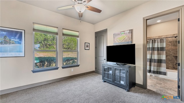 living room featuring light colored carpet and ceiling fan