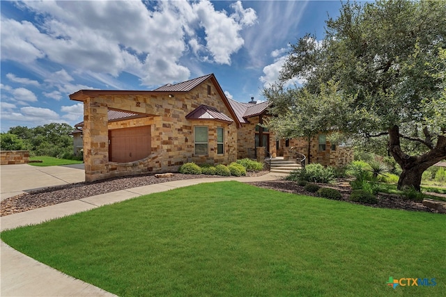 view of front of home with a garage and a front yard