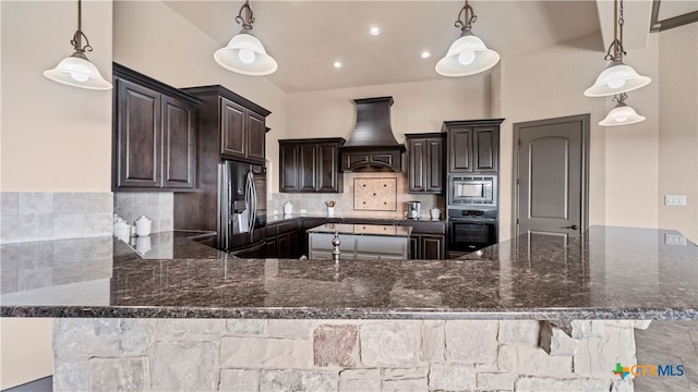 kitchen with appliances with stainless steel finishes and hanging light fixtures