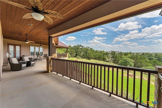 balcony with ceiling fan and an outdoor living space