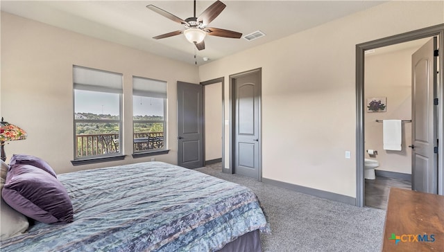 bedroom featuring ensuite bathroom, ceiling fan, and dark carpet