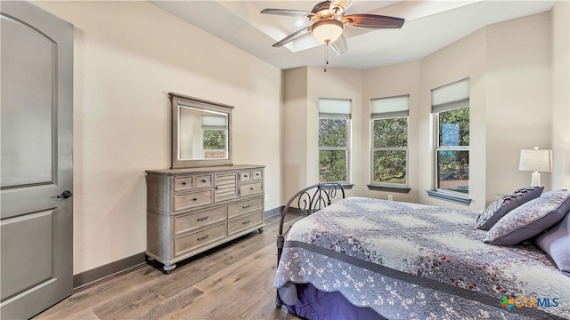 bedroom with ceiling fan and light wood-type flooring