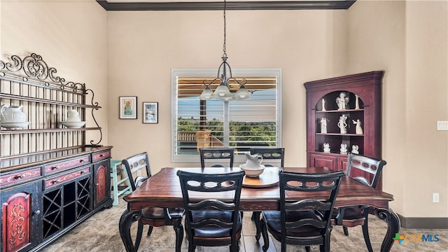 dining area featuring a notable chandelier and ornamental molding