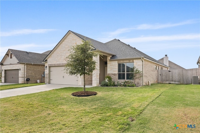 view of front of property with a front lawn, concrete driveway, fence, and an attached garage