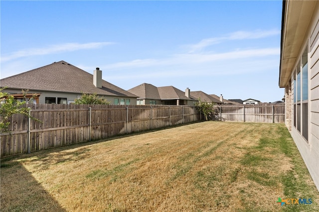 view of yard with a fenced backyard