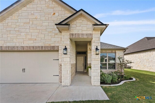 10205 Eaglefire Dr, Temple, TX 76502 - french country style house with stone siding, a front yard, and driveway