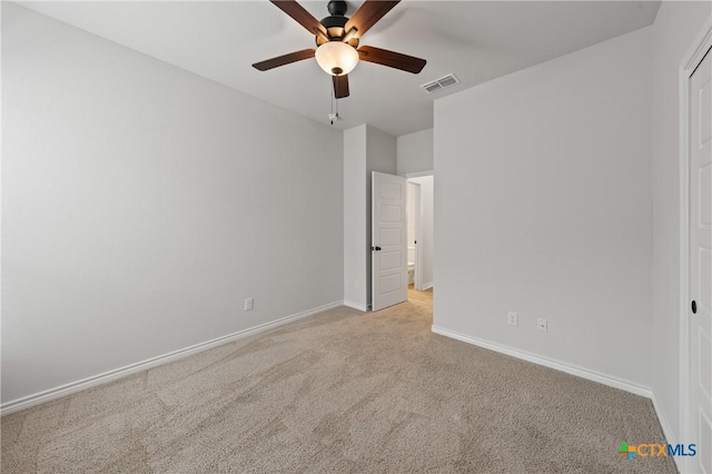 unfurnished bedroom featuring baseboards, visible vents, a ceiling fan, and light colored carpet