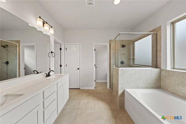 bathroom featuring a stall shower, visible vents, a sink, tile patterned flooring, and a bath