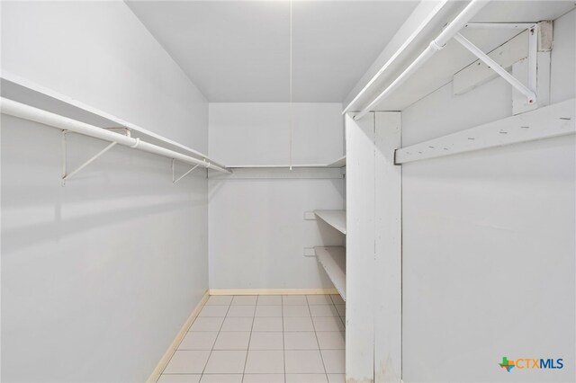 spacious closet with light tile patterned floors