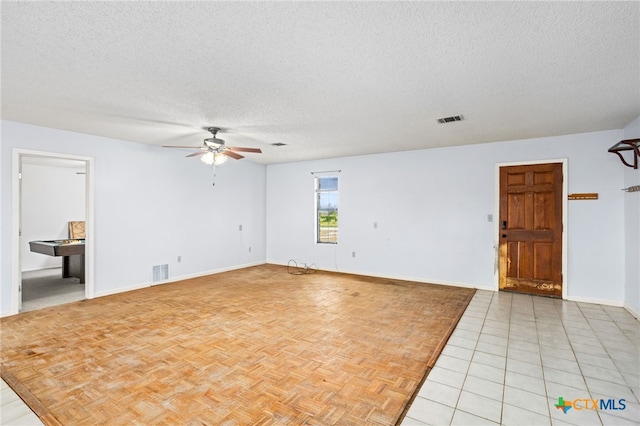 unfurnished room featuring ceiling fan, a textured ceiling, and light tile patterned floors