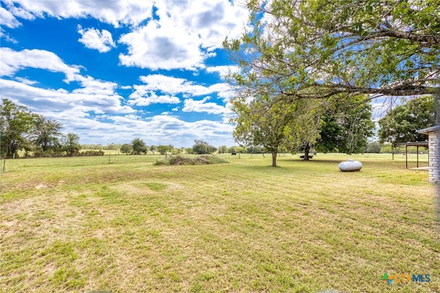 view of yard with a rural view