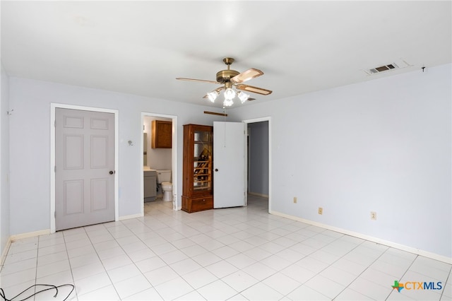 spare room featuring light tile patterned floors and ceiling fan