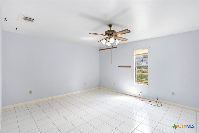 tiled empty room featuring ceiling fan