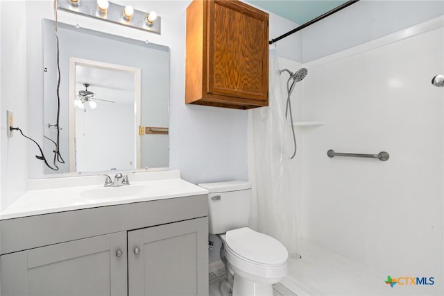 bathroom featuring toilet, vanity, ceiling fan, and curtained shower