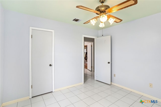 unfurnished bedroom featuring ceiling fan and light tile patterned floors