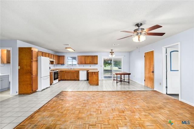 kitchen with ceiling fan, a textured ceiling, white appliances, and light tile patterned flooring