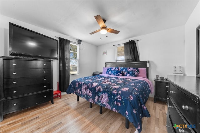 bedroom with light hardwood / wood-style floors and ceiling fan