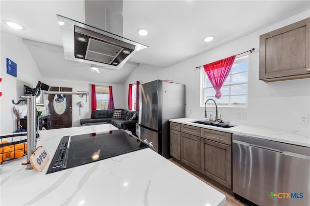 kitchen featuring a wealth of natural light, stainless steel appliances, sink, and vaulted ceiling