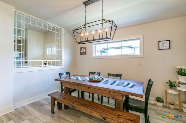 dining room featuring baseboards and light wood finished floors