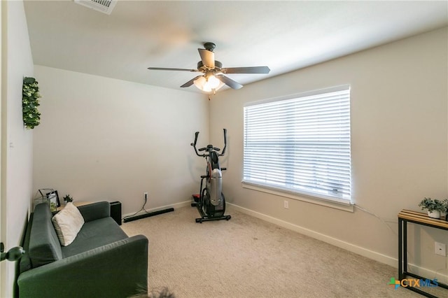 exercise room featuring carpet flooring, ceiling fan, visible vents, and baseboards