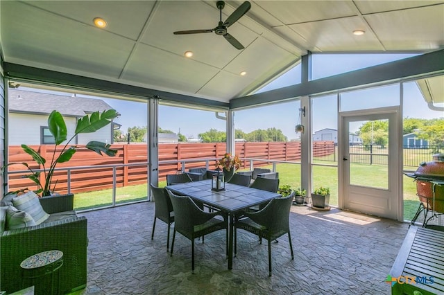 sunroom featuring ceiling fan and lofted ceiling with beams