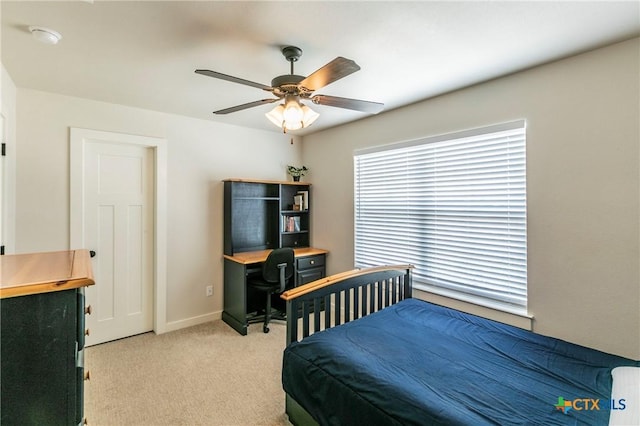 bedroom with light carpet, ceiling fan, and baseboards