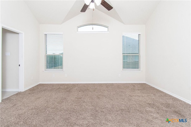 carpeted empty room with ceiling fan and lofted ceiling