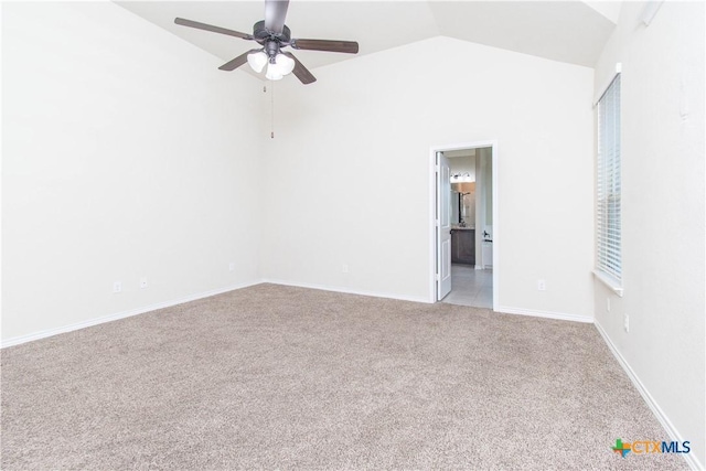 spare room with lofted ceiling, ceiling fan, and light colored carpet