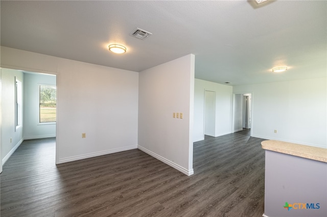 unfurnished room with dark hardwood / wood-style flooring