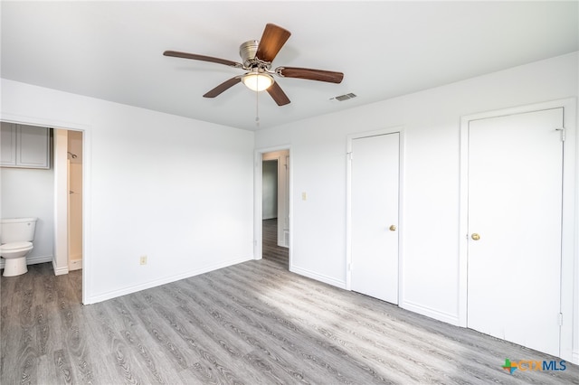 unfurnished bedroom featuring ensuite bathroom, ceiling fan, and light hardwood / wood-style floors