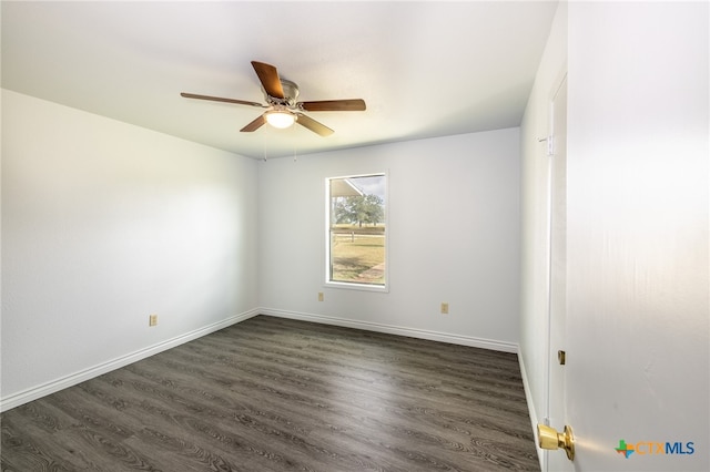 empty room with dark wood-type flooring and ceiling fan