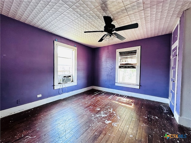 unfurnished room featuring hardwood / wood-style floors, a wealth of natural light, ceiling fan, and cooling unit