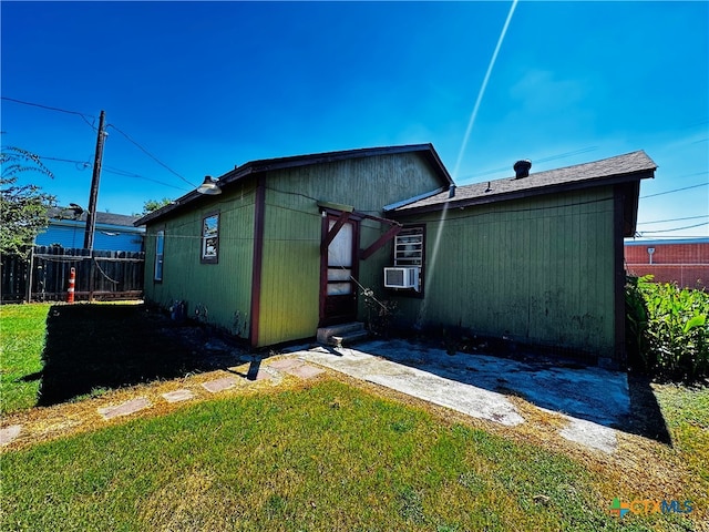 back of property with cooling unit and a yard