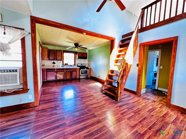 unfurnished living room featuring hardwood / wood-style flooring, ceiling fan, and cooling unit