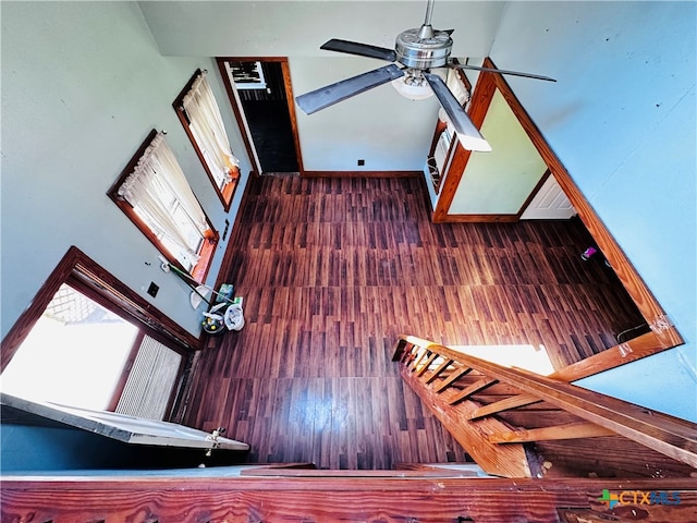 interior space with ceiling fan and dark hardwood / wood-style floors