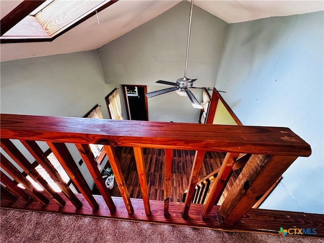 staircase with carpet floors and ceiling fan