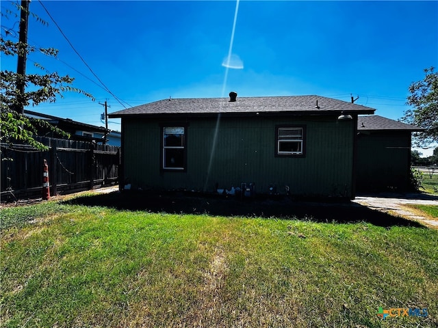 rear view of property with a yard