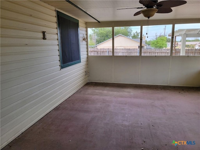 unfurnished sunroom featuring a wealth of natural light and ceiling fan