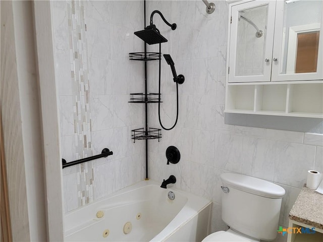 bathroom featuring tiled shower / bath combo, tile walls, and toilet